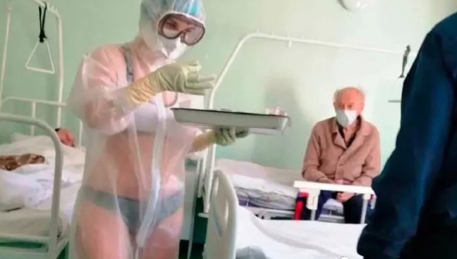 An unidentified Russian nurse putting on just her lingerie under transparent